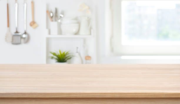 istock Wooden texture table top on blurred kitchen window background 1223182738