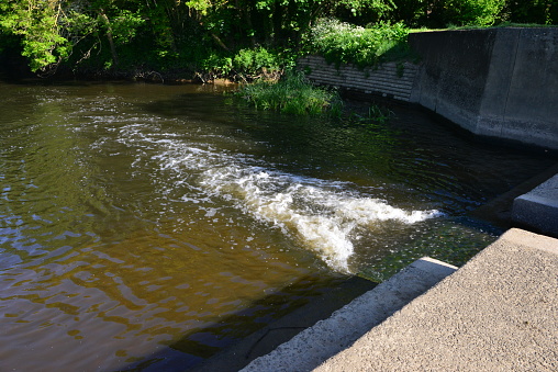 Water flowing through a Weir on the river Mole in May 2020