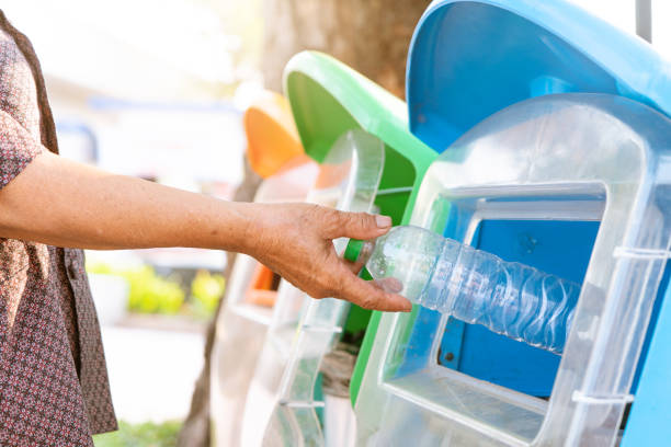 old women hand throwing away the garbage to the bin/trash, sorting waste/garbage before drop to the bin