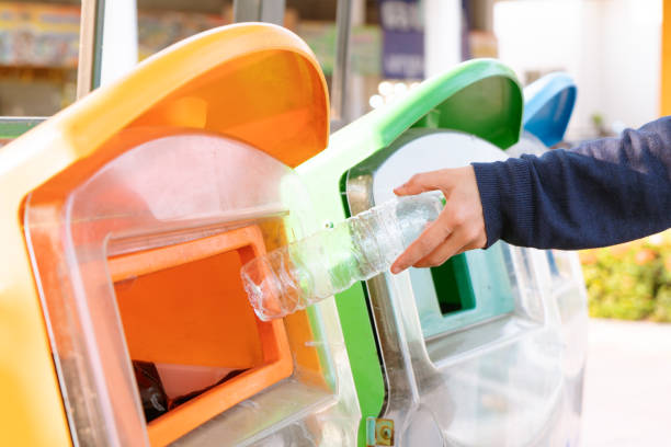 istock women hand throwing away the garbage to the bin/trash, sorting waste/garbage before drop to the bin 1223182885
