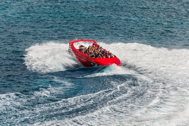Round-trip Twister Jet Boat ride in San Miguel de Cozumel, Mexico San Miguel de Cozumel, Mexico - April 25, 2019: View of the Twister Jet Boat ride in harbor of San Miguel de Cozumel, Caribbean. People enjoy the speedboat swerves, jumps and spins! san miguel de cozumel stock pictures, royalty-free photos & images