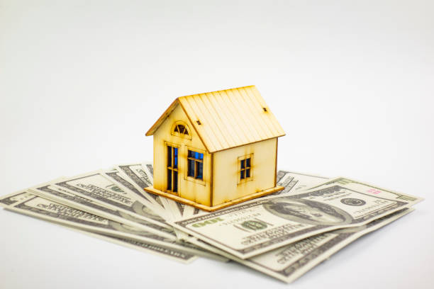 istock House and money on blue background 1223183820