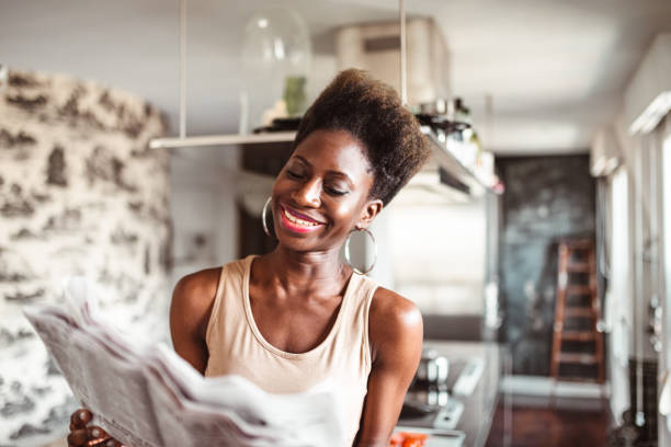 istock happiness woman in the kitchen reading a newspaper 1223184056
