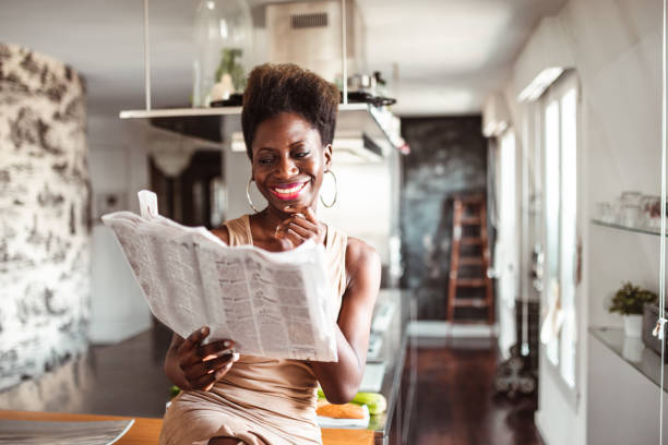 istock happiness woman in the kitchen reading a newspaper 1223184136
