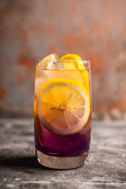 istock Gin based colorful cocktail with lemon and lavender liqueur on the rustic background 1223184212