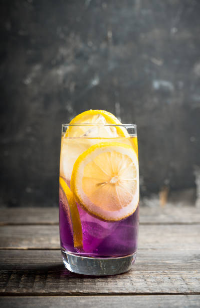 istock Gin based colorful cocktail with lemon and lavender liqueur on the rustic background 1223184217