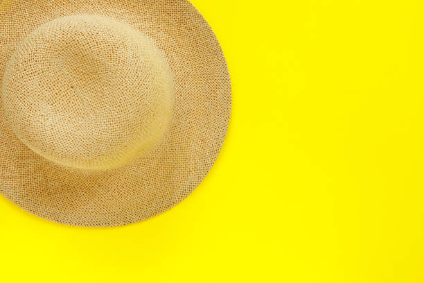 istock Fashionable straw hat on yellow paper background. 1223185795