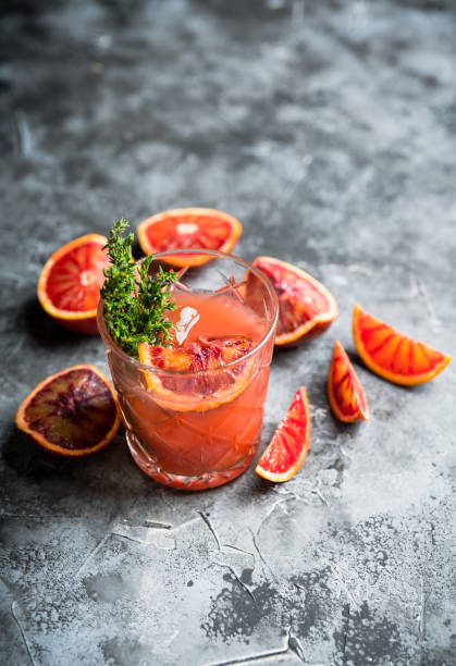 istock Old-fashioned cocktail with blood oranges and thyme on the rustic background 1223185917