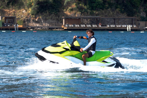 Man drives yellow jet ski on turquoise sea on a blue day