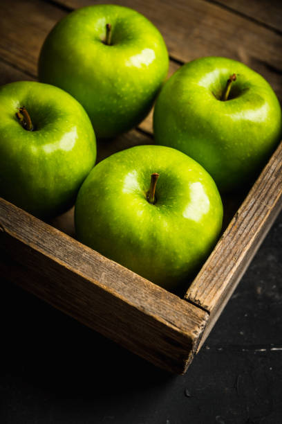 istock Close-up green apples on the rustic wooden background 1223186609