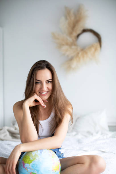 istock Woman at home with a globe. 1223187540