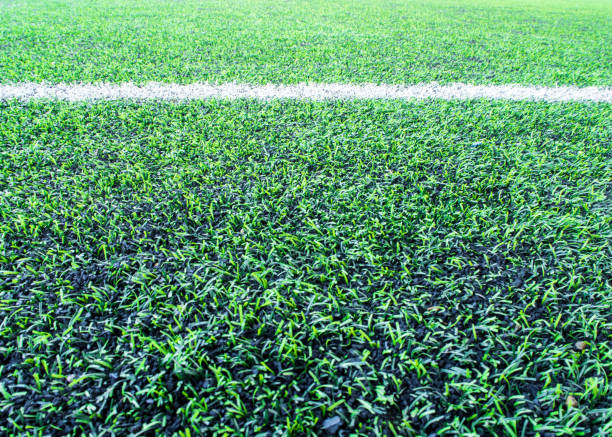 texture of plastic artificial grass and the rubber pellets on school yard - soccer soccer field artificial turf man made material imagens e fotografias de stock