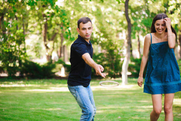 istock Guy and girl compete in the ring toss 1223189941