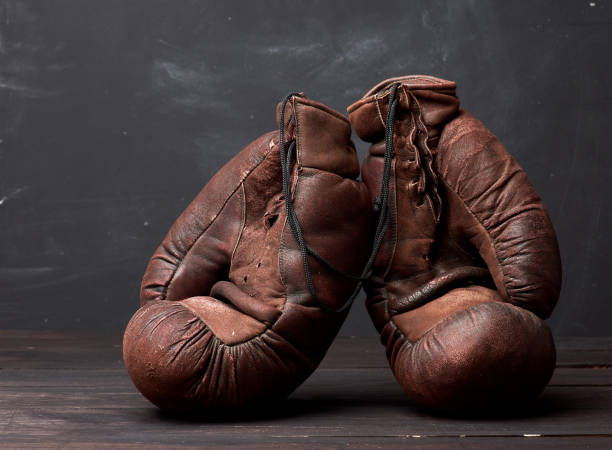 istock brown leather vintage boxing gloves on a black background 1223190306