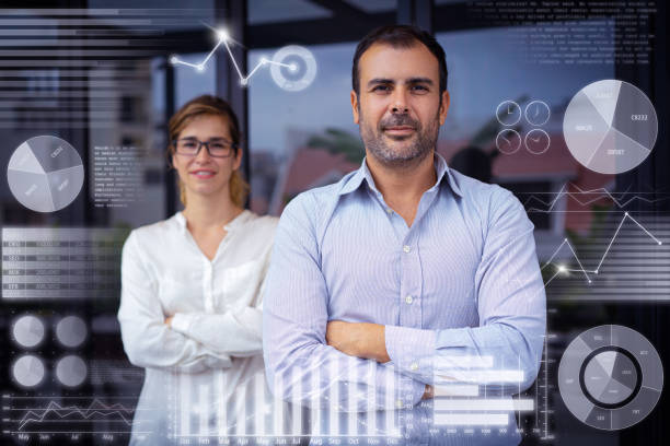 istock Male leader with colleague and virtual statistic graphics 1223190591