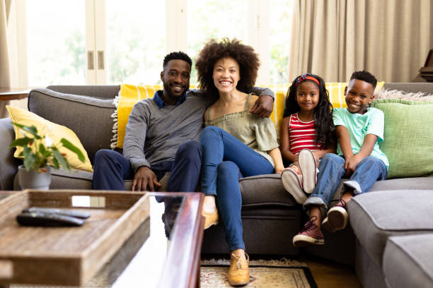 istock Mixed race family spending time together sitting on a couch 1223190680