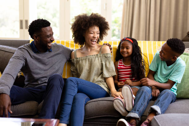 istock Mixed race family spending time together sitting on a couch 1223190723