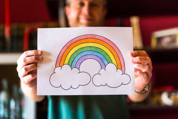 istock Man holding rainbow during Covid-19 pandemic 1223191700