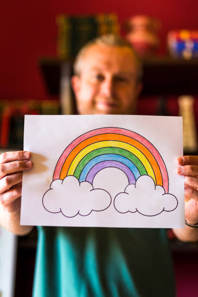istock Man holding rainbow during Covid-19 pandemic 1223191710