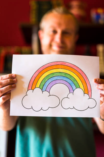 istock Man holding rainbow during Covid-19 pandemic 1223191711