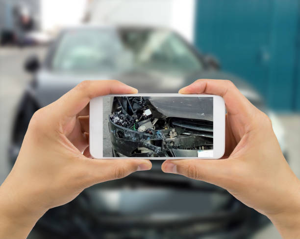 istock Man photographing his car with damages 1223193051