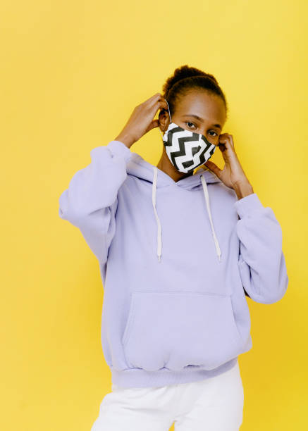 istock young woman puts on a mask during the coronavirus 1223193804