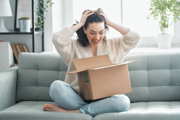 istock woman is unpacking cardboard 1223194699
