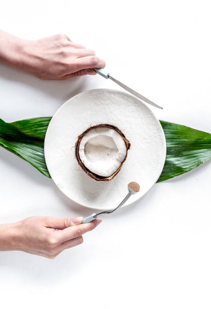 coconut on plate top view on white background