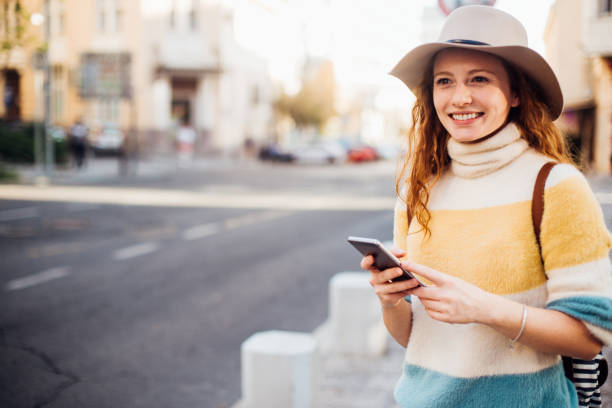 istock Girl on vacation walking and using smartphone 1223198792