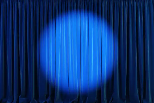 Photo of Blue curtains with spotlight or flash.