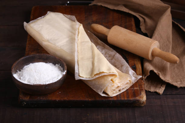 flaky homemade dough raw flaky homemade dough on the table filo pastry stock pictures, royalty-free photos & images