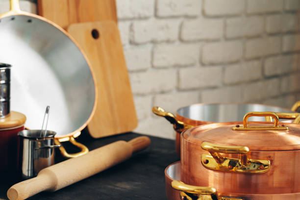 istock Copper cookware with wooden kitchen utensils close up 1223200346