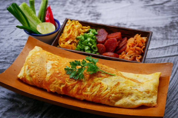 Omelet Wrapping Fried Rice with  Chili Paste stock photo