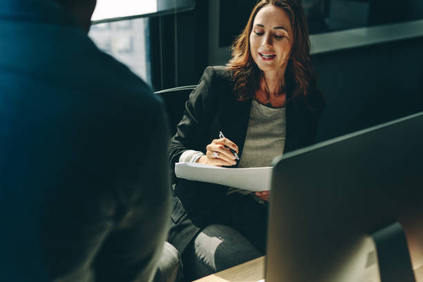 istock Business colleagues discussing over a report in office 1223201707