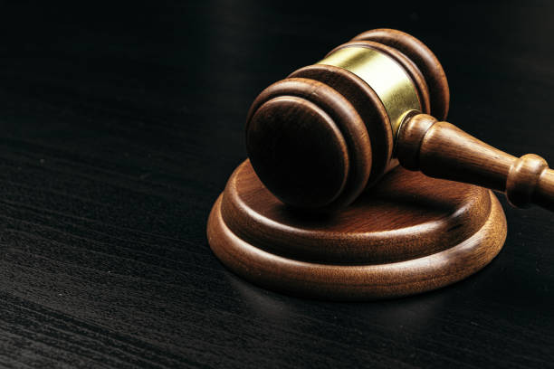 istock Judge's gavel on wooden table in dark 1223203363