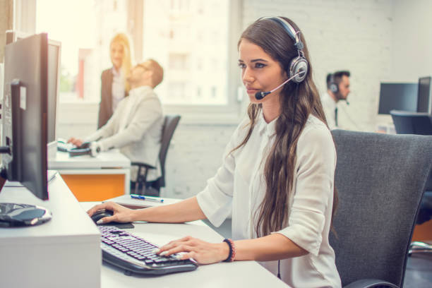 istock Portrait of attractive female support phone operator in headset at workplace 1223203480