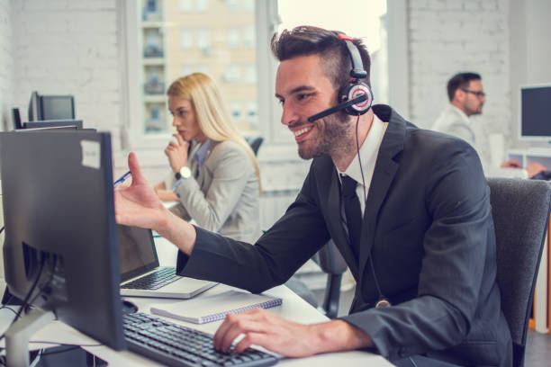 istock Handsome businessman sitting working on computer in office. 1223203784