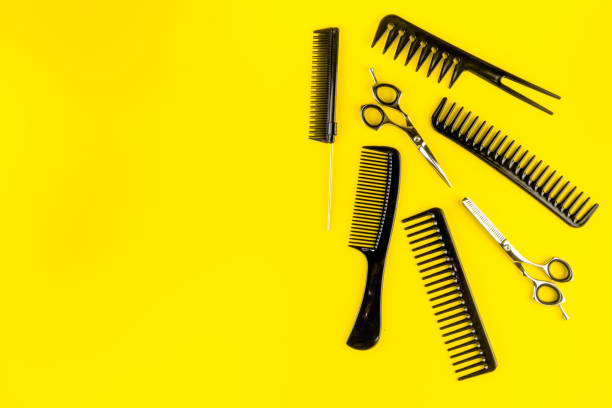 istock Combs, hairbrush, scissors on yellow desk from above copy space 1223205188