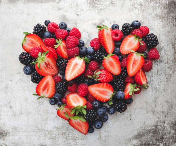 heart, formed from different berries heart, formed from different berries like strawberries, blackberries, raspberries and blueberries strawberry heart shape stock pictures, royalty-free photos & images