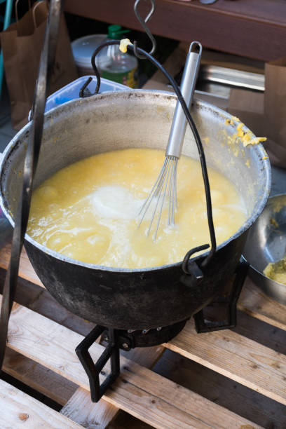 Cooking pot over campfire, mamaliga or polenta preparing open grill steaming. Cooking pot over campfire, mamaliga or polenta preparing open grill steaming. Outdoor fireplace camping concept. Traditional dinner meal preparation in nature cooking over wood fire open flames. mamaliga stock pictures, royalty-free photos & images