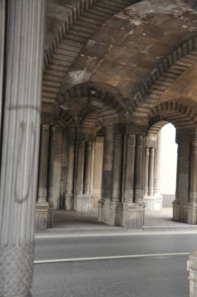 istock Tunnel structure with historical columns, through which the vehicle road passes 1223206712