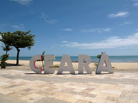 Fortaleza, Ceara / Brazil - July, 27, 2018 - arriving signage tourism board with Ceara inscription in large, colorful letters on the beach and sea in the city of Fortaleza, state of Ceara, Brazil