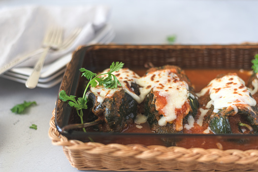 Poblano stuffed chile with meat and cheese in tomato sauce, healthy Mexican food