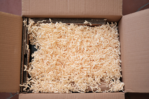 Open box with paper chipboard. This material is used to fill shipping boxes.