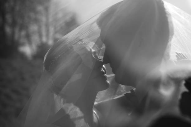 istock Young beautiful bride take shelter under a photo. Bright backlight shines in the frame 1223210801