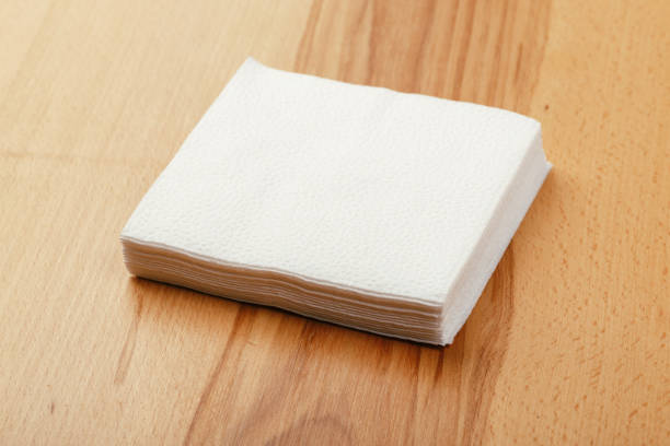 istock white paper napkin or tissue on the wooden table background. 1223211718