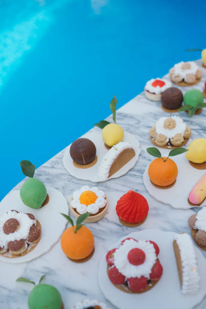istock Desserts in an outdoors Birthday party. Sweets by the pool. 1223212451