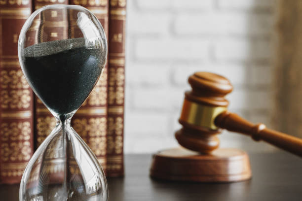 istock Court concept. Hourglass and judge gavel on table 1223213748