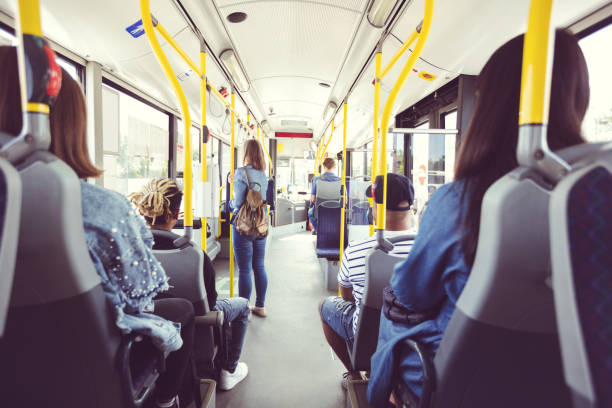 Back view of passengers commuting by public transport Group of people traveling in bus. Passengers commuting by public transport. Back view, wide angle. public transportation stock pictures, royalty-free photos & images