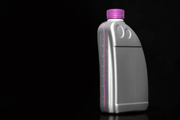 istock Engine oil bottle on black background, close up. 1223214894